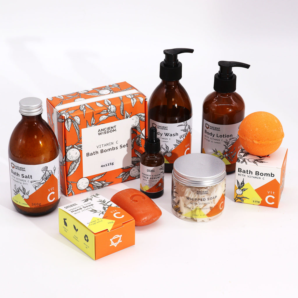 Aromatherapy Body Wash with Vitamin C in a clear pump bottle. The liquid soap has a vibrant orange colour, reflecting its citrus ingredients. The elegant bottle design showcases the product's premium quality.