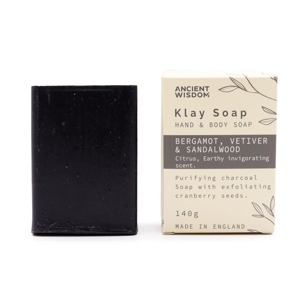 Klay Soap - Bergamot & Sandalwood. A rectangular bar of natural, dark-coloured soap with visible cranberry seeds for exfoliation. The soap is infused with Fuller's earth clay and activated charcoal for detoxifying properties.
