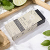 Klay Soap - Bergamot & Sandalwood. A rectangular bar of natural, dark-coloured soap with visible cranberry seeds for exfoliation. The soap is infused with Fuller's earth clay and activated charcoal for detoxifying properties.